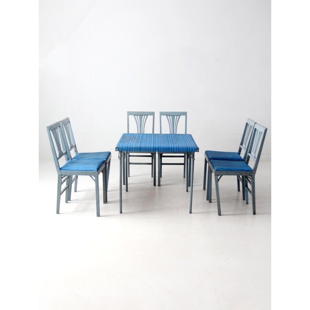 A vintage folding dinette set combining an early Swayder Bros. Samsonite table with six matching Leg-O-Matic chairs in...