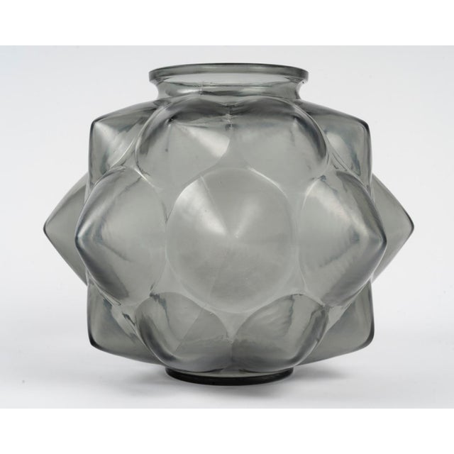 René Lalique "Champagne" Vase The "Champagne" vase, created by René Lalique, model no. 1004, was created on December 8,...