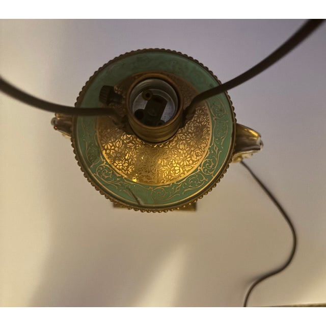 Beautiful porcelain urn table lamp featuring gilt decoration and a classical portrait medallion. Likely dates from the...