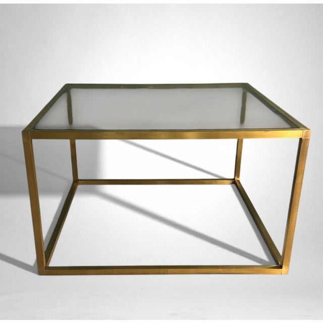 Refined and elegant Italian coffee table in brass with a smoked glass top. The linear and rigorous structure is crafted...