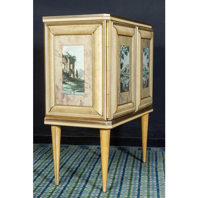 This fancy bar cabinet designed in Italy by Umberto Mascagni.This piece features a cream colored vinyl with anodized...