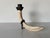 A sculptural vintage candle holder crafted from faux tusk resin, designed to mimic the look of natural ivory with rich...