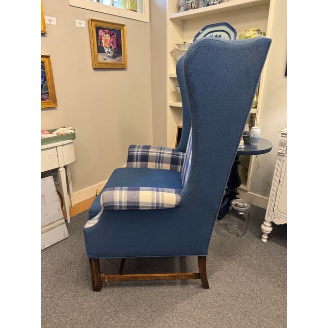 This is a Late 20th Century vintage oversized wing-back chair. It has a designer plaid flannel fabric mixed with a solid...
