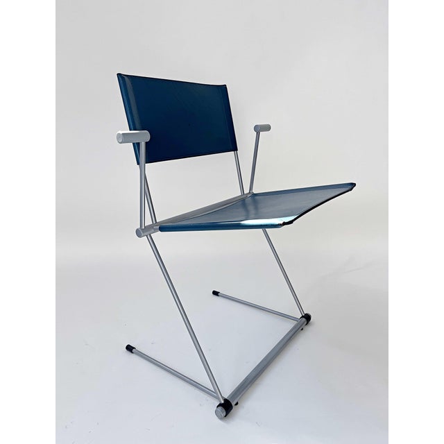 There are two grey and two teal coloured chairs available This piece has an attribution mark, I am sure that it is...