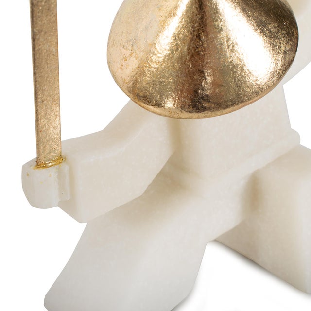 Add a playful edge to your space with these modern warrior sculptures, featuring white geometric forms and gold accents....