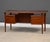 A mid century modern teak floating top desk designed by Peter Løvig Nielsen with a drawer with the capability for hanging...