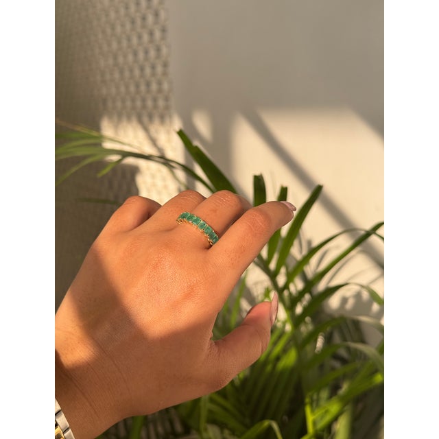 This elegant Half Band ring is features a 1.59 carat of natural emeralds set in 14K yellow gold. Each measuring...