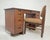 A mahogany writing desk and chair designed by Frank Lloyd Wright as part of his collaboration with Heritage Henredon in...