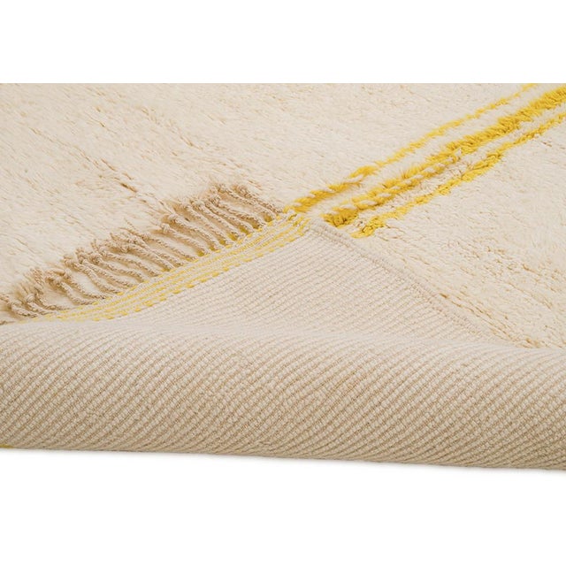 Elegant hand-knotted wool rug in warm Ivory, featuring minimalist Yellow linework. This unique piece blends traditional...