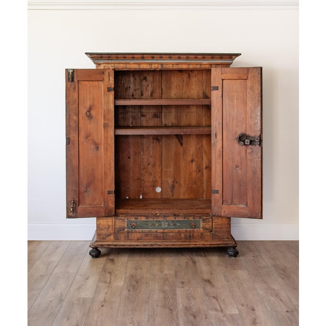 A rare Alpine Bauernschrank from the Austro-Tyrolean tradition, painted in the rococo folk idiom that flourished across...