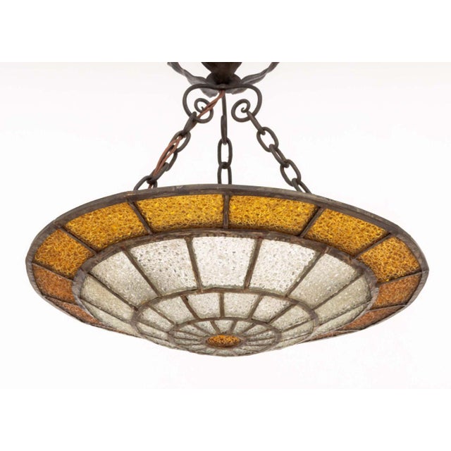Art Deco Textured Glass and Iron Pendant Light, with flower form fixture and amber-colored and clear glass. 18.5" H x 16"...