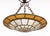 Art Deco Textured Glass and Iron Pendant Light, with flower form fixture and amber-colored and clear glass. 18.5" H x 16"...