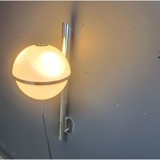 Very rare Pusicona Wall Lamp designed by Franco Micolitti for Artemide. Made ouf of chromed metal and a white glass globe....