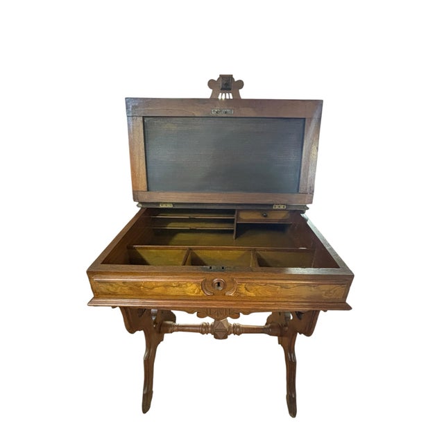 Elegant late Victorian walnut writing desk featuring a lift-top writing surface, decorative gallery back, and beautifully...