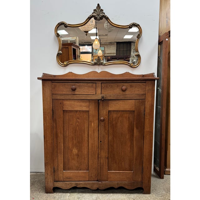This beautiful antique American primitive jelly cupboard dates to approximately 1890. Crafted from solid walnut, the...
