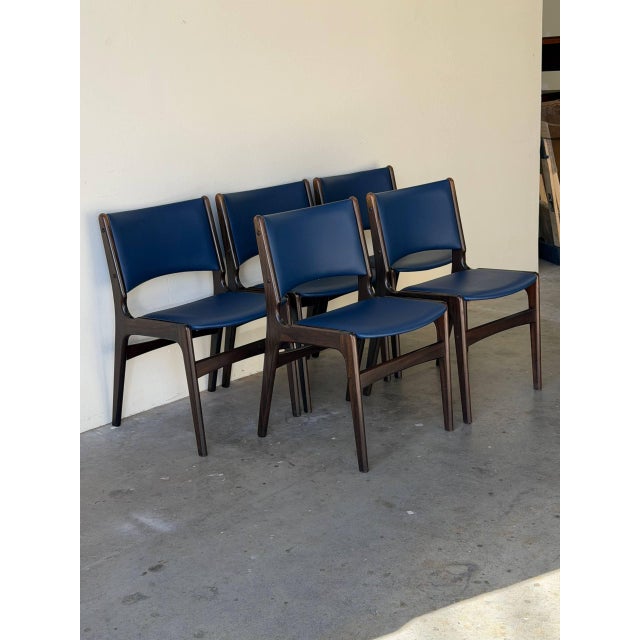 Beautiful set of five Mid Century Modern dining chairs in style of Johannes Andersen, crafted in richly toned teak with...
