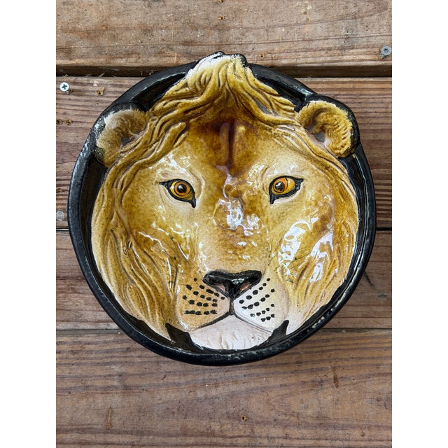 Striking vintage sculptural wall plate featuring a hand-painted lion rendered in rich, dimensional glaze. Crafted in...