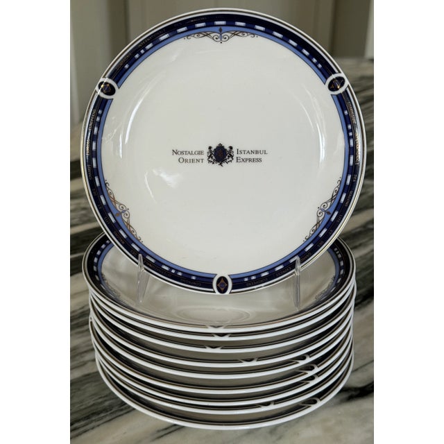 Presenting the Orient Express vintage dessert plate in shades of sapphire blue and gold accents on an all-white backdrop...