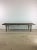 This mid century modern slat bench / coffee table features hardwood construction, original walnut finish, and tall tapered...