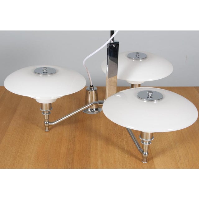 Elegant three-arm brass chandelier "PH akademikrone" by Poul Henningsen for Louis Poulsen, 3/2 opal glass shade set,...