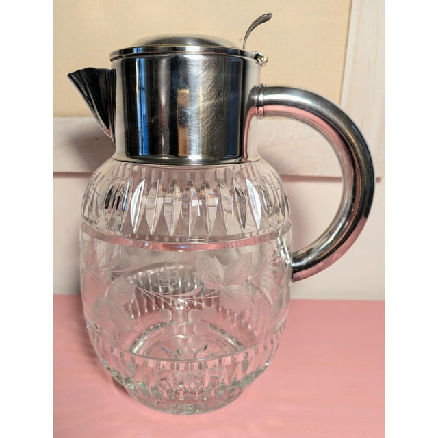 This elegant cut crystal water pitcher was made by Deutsches Reich Gebrauchsmuster (D.R.G.M.) of Germany and likely dates...
