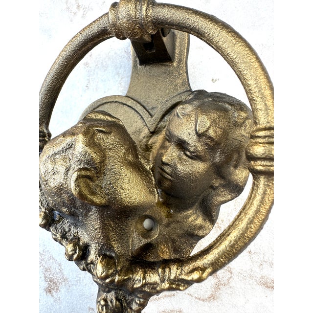 Gold-Tone Cast Metal Kissing Couple Door Knocker A charming sculptural door knocker featuring two facing profiles within a...