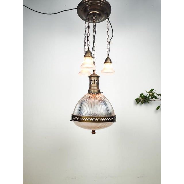 Beautiful large early Holophane chandelier constructed out of pressed glass with brass fixture and ring. This large 2 part...