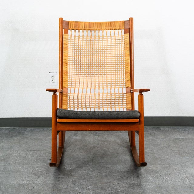 Denmark, ca. 1950s. An elegant rocking chair by Hans Olsen for Juul Kristensen. Features a solid teak frame with straight...