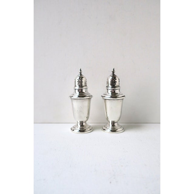 A pair of sterling silver salt and pepper shakers from Gorham Silversmiths, circa early-20th century, America. Classic...