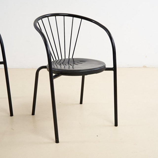 Pair of black chairs in sheet metal and tubular metal height: 76 width: 50 seat height: 46 additional information style:...