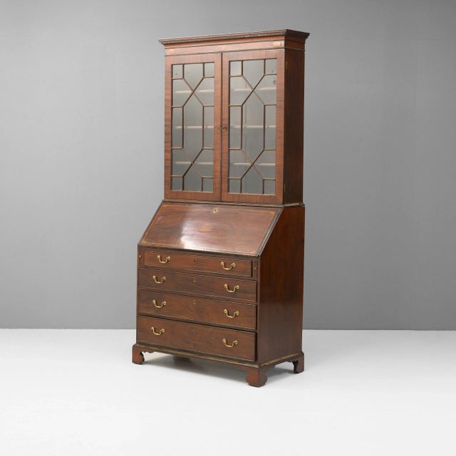 Mahogany bureau and associated bookcase top with astragal glazed doors. Circa 1780.