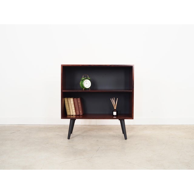 The bookcase was made in the 1970s, Danish production. The structure is covered with rosewood veneer. Legs made of solid...