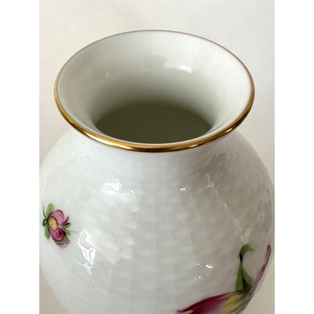 This Herend porcelain flower vase is hand-painted and features vibrant summertime flowers in shades of pink, orange,...