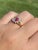 The Carboor: Natural Ruby and Diamond Ring in Yellow Gold. The ring centers on an oval brilliant cut natural ruby with a...