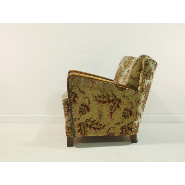 This charming mid-century armchair dates back to the 1950s and combines elegant lines with loving details. The armrests...