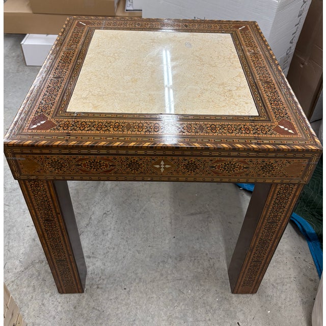 Vintage Moroccan satin wood accent table inland with exotic woods and mother of pearl. The center of the table features a...