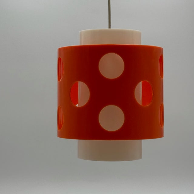 Original 70s lamp made of polycarbonate with orange and white interplay. A bold statement that radiates playful energy -...