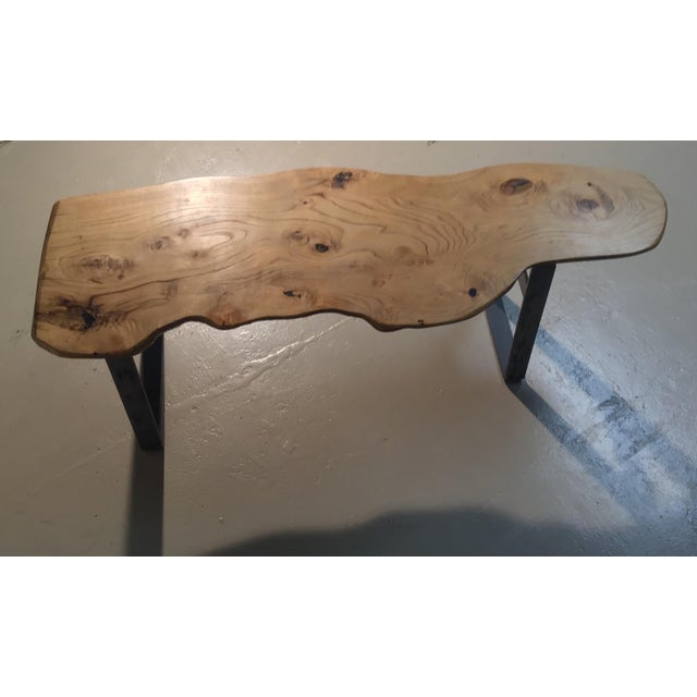 Bench made of Chestnut wood syringed with resin and with brushed steel structure.