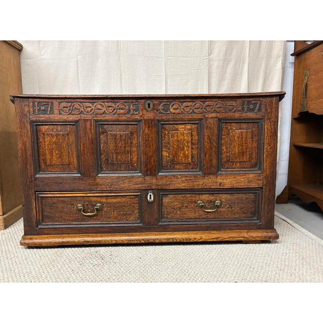 A truly exceptional 18th century English oak mule chest. Beautifully carved details including the date of 1717 and the...