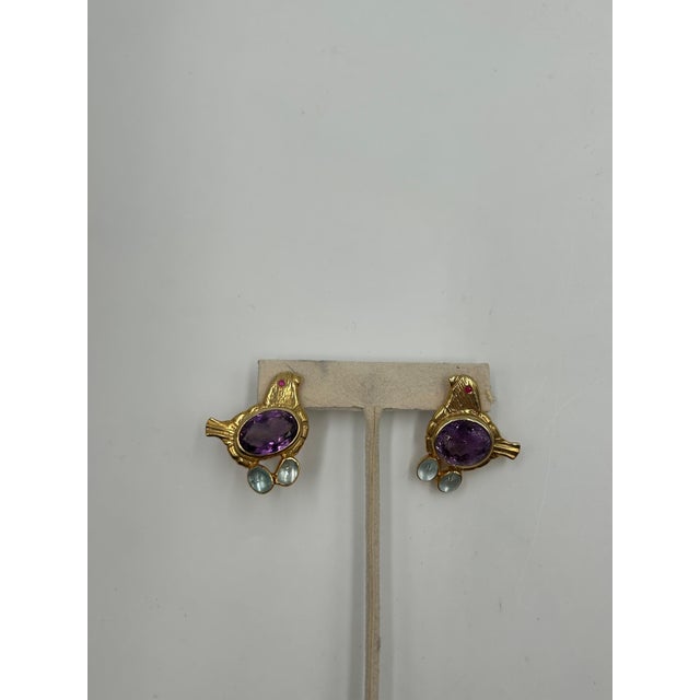 Unique and artfully crafted, these vintage gold-toned silver bird earrings feature an intricate design accented with real...