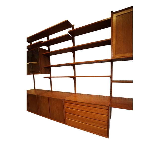 A whole wall of danish design, warm teak and thoughtful possibilities! this generous shelving system by poul cadovius for...