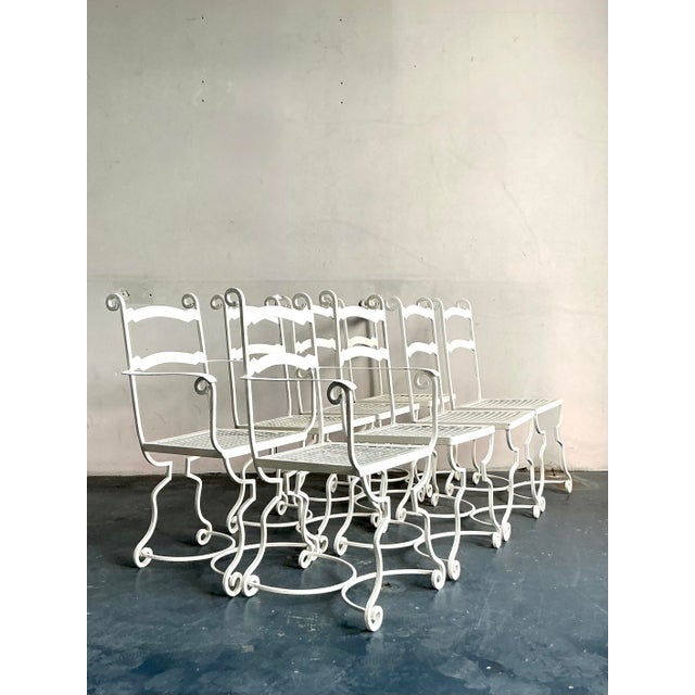 This exquisite set of eight wrought iron dining chairs captures the sophisticated outdoor elegance of the French Riviera...