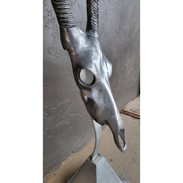 A polished aluminum floor or wall sculpture of a gazelle by Arthur Court. Cast aluminum skull and antlers mounted to a...