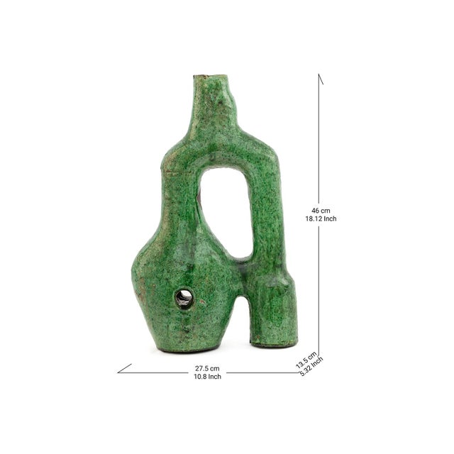 An abstract, biomorphic silhouette rises in the iconic green glaze that has made Tamegroute pottery famous the world over,...