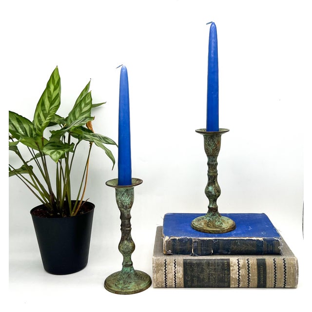 Distinctive pair of vintage brass candlesticks with richly aged green verdigris patina. Each features a tall turned...