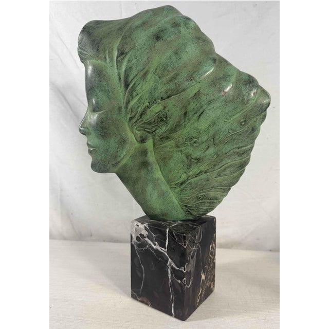 Original Alva Museum Replicas foil label on felt base. Profile bust of a woman with windswept hair by Peggy Mach,...