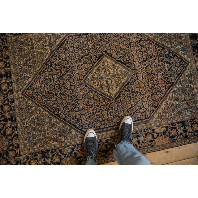 :: Diamond shaped center medallion atop a covered Herati main field. Wide banded main border in an unusual design...