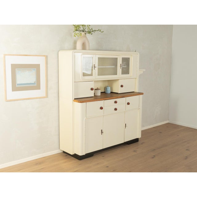 A wonderful two-part Art Deco kitchen cabinet from the 1920s. High-quality veneered wood construction with six cabinet...