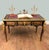 A magnificent french boulle style writing desk, richly decorated with ormolu mounts and vibrant red and black panels in...
