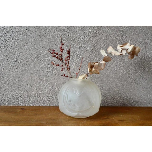 This charming ball vase, decorated with stylized plant motifs, is carried out according to the technique of the molded...